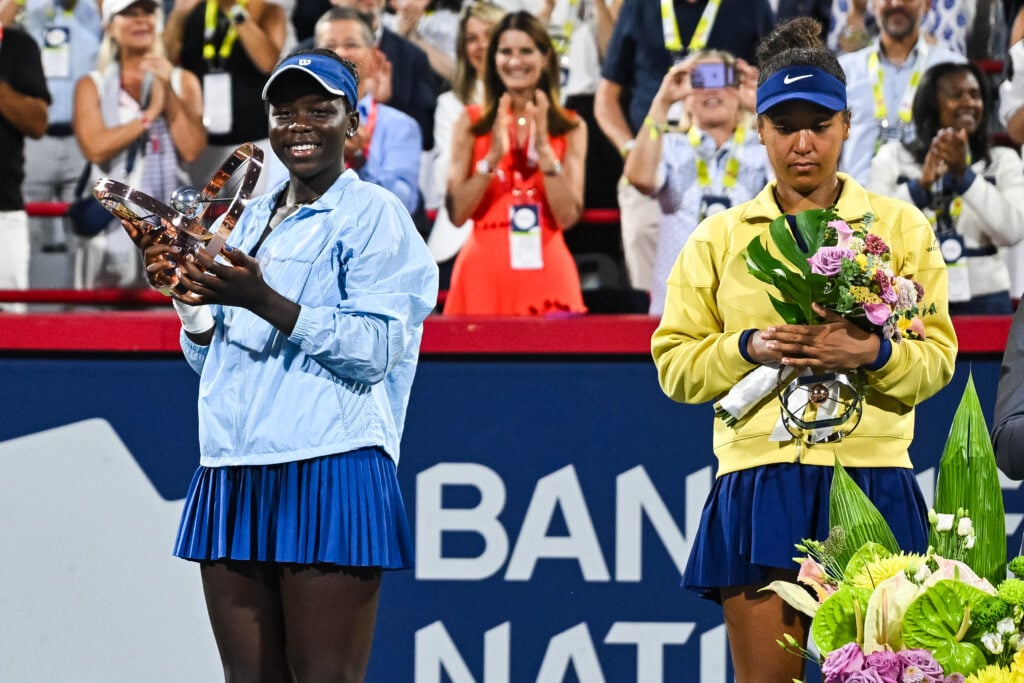 Victoria Mboko holds her trophy after the singles final beside runner up Naomi Osaka at WTA National Bank Open.