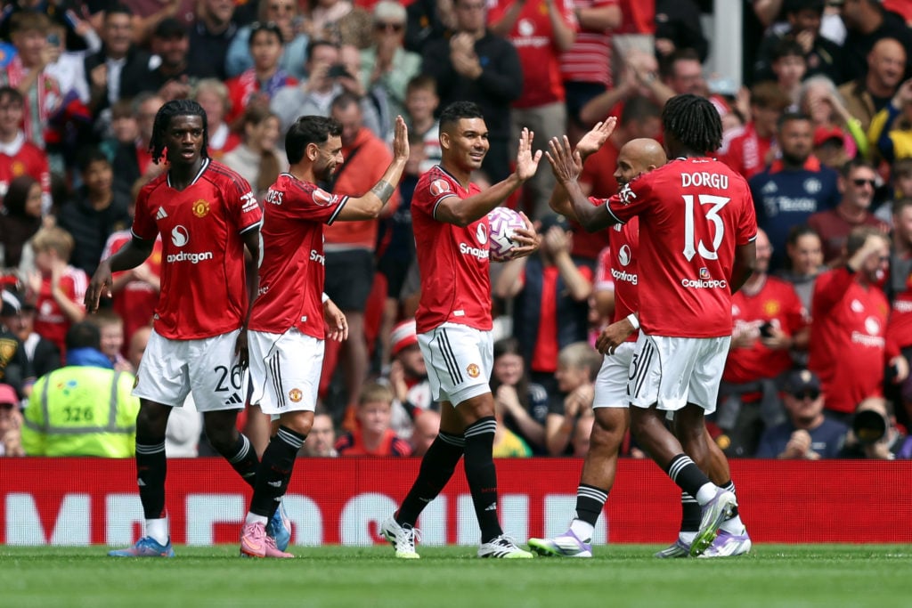 Casemiro of Manchester United celebrates scoring his teams first goal with teammates Bruno Fernandes and Patrick Dorgu during the pre-season friendly match between Manchester United and ACF Fiorentina at Old Trafford on August 09, 2025