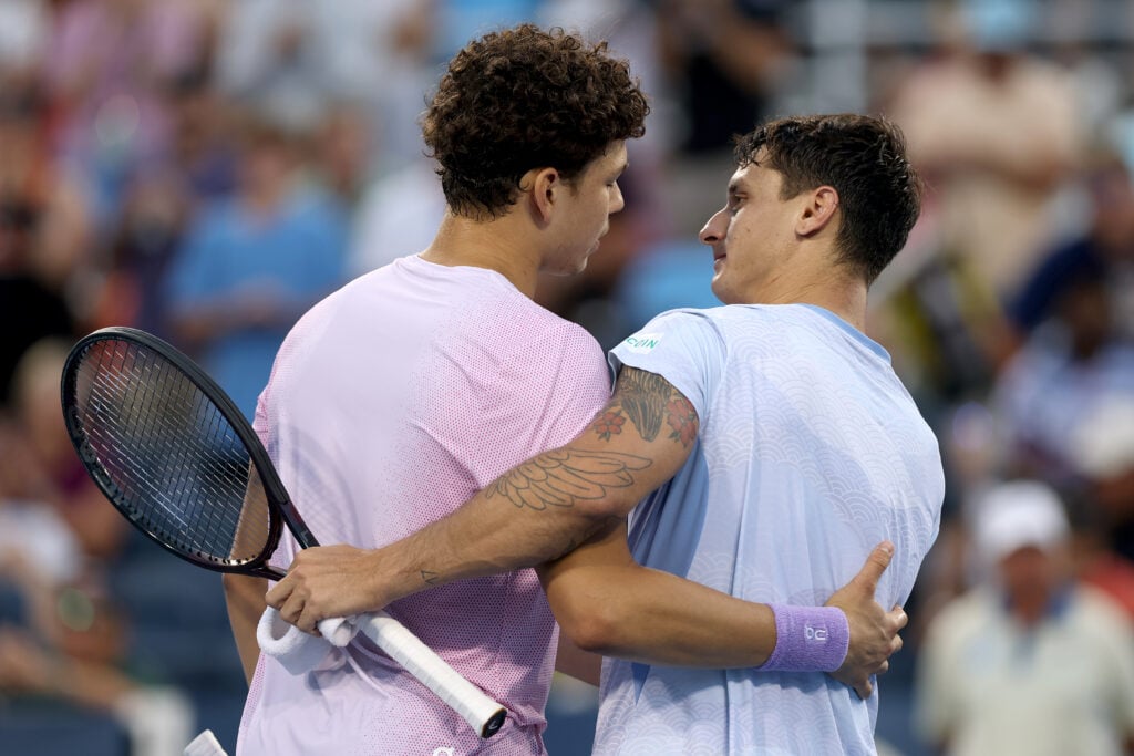 Ben Shelton of United States meets Camilo Ugo Carabelli of Argentina at the net after Carabelli retired from the match during the Cincinnati Open at Lindner Family Tennis Center.