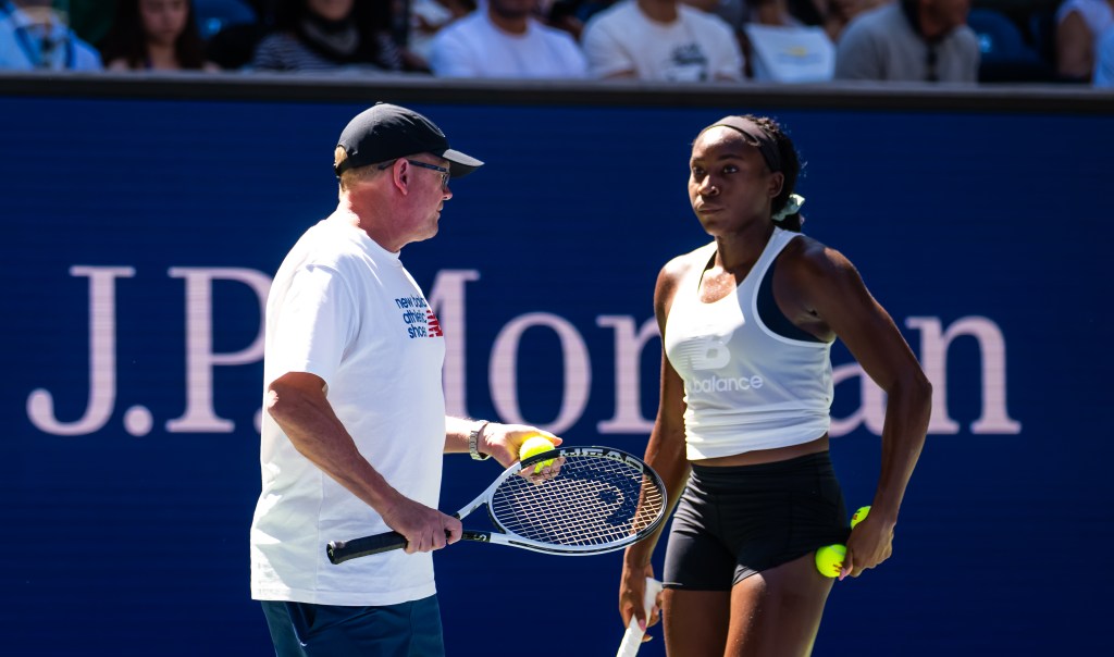 Coco Gauff listens to biomechanics expert and new coach Gavin MacMillan during practice ahead of the US Open at USTA Billie Jean King National Tennis Center on August 22, 2025 in New York City.