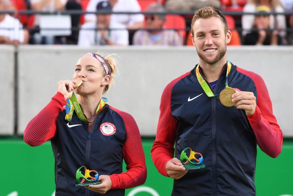 Bethanie Mattek-Sands and Jack Sock pose with their Olympic gold medals at the Rio Games