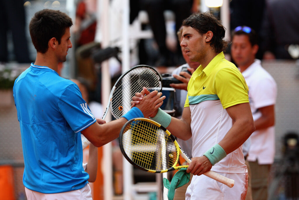 Rafael Nadal and Novak Djokovic shake hands after their 2009 Madrid Tennis Open semi-final