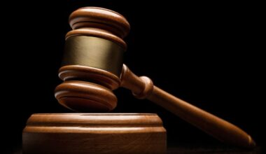 Close-up view of wooden gavel on black background