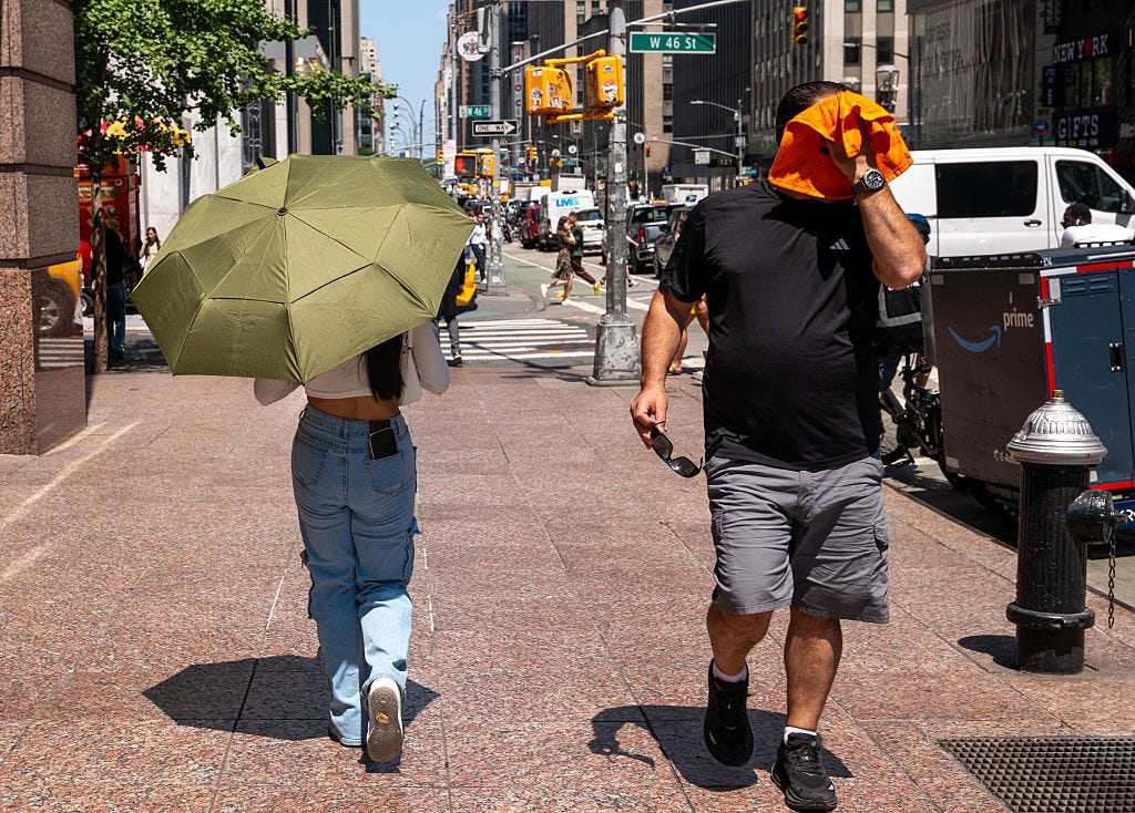 People try to stay cool on the sweltering streets of Manhattan as the region experiences another heatwave on July 29, 2025 in New York City