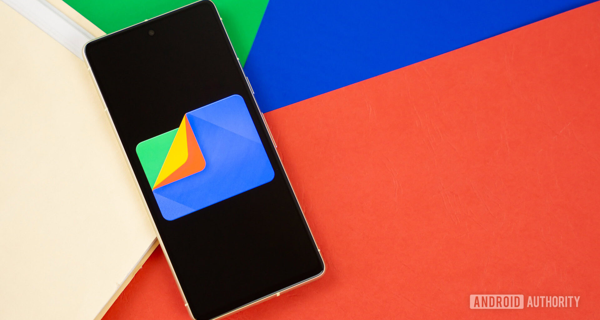 Google Files app logo on smartphone with manila folder and colorful background Stock photo 3