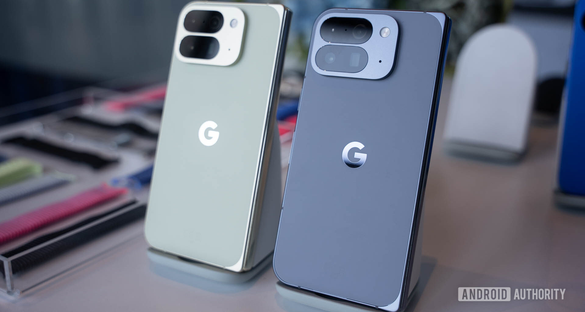 Google Pixel 10 Pro Fold in Jade next to Google Pixel 10 Pro Fold in Moonstone on stands