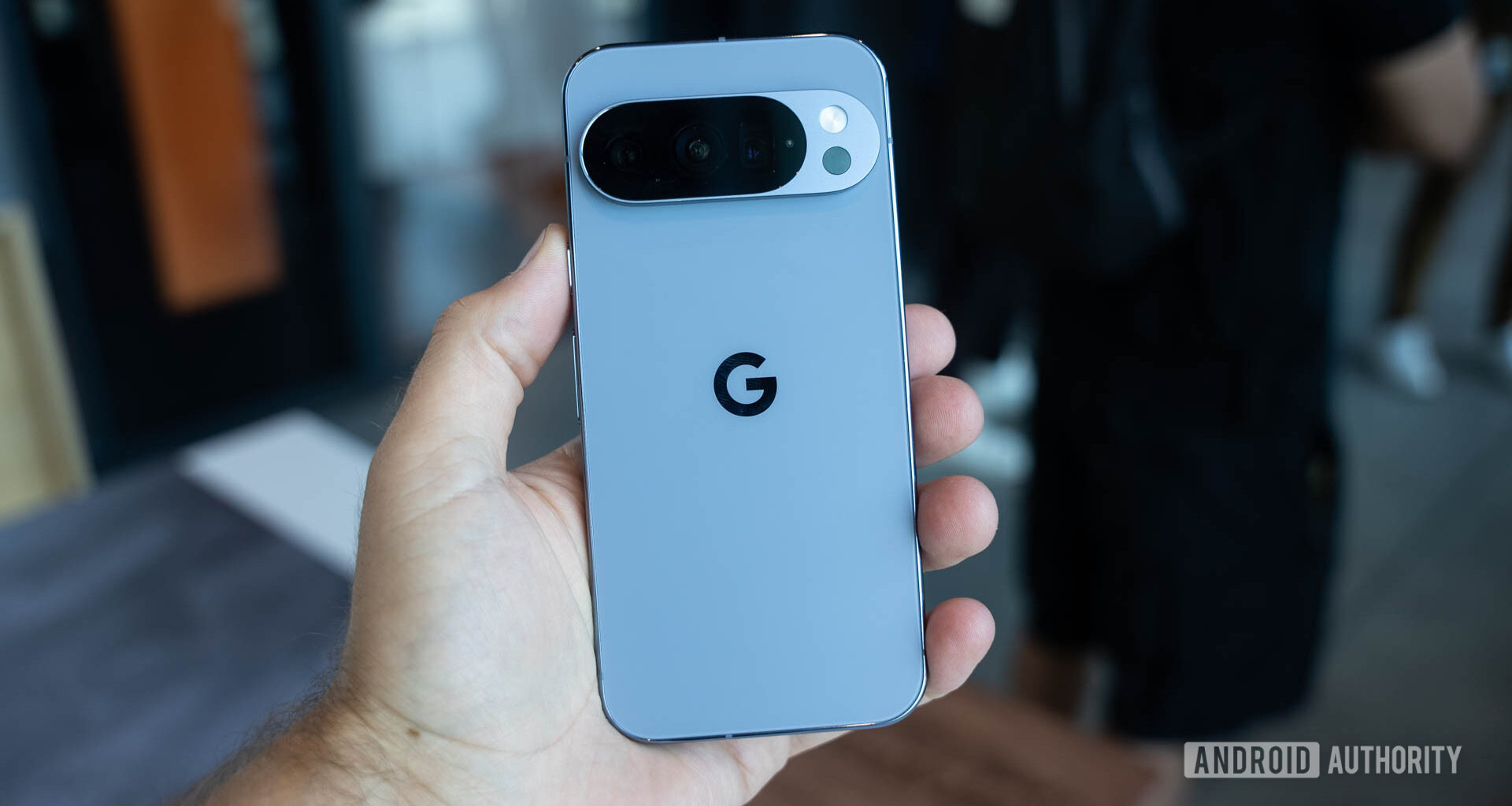 Google Pixel 10 Pro in Moonstone in a man's hands showing back