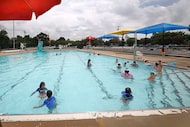 People swim in Walnut Hill Swimming Pool, Wednesday, July 2, 2025, in Dallas.