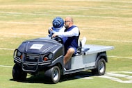 Dallas Cowboys running back Jaydon Blue (34) is carted off the field with an injury...
