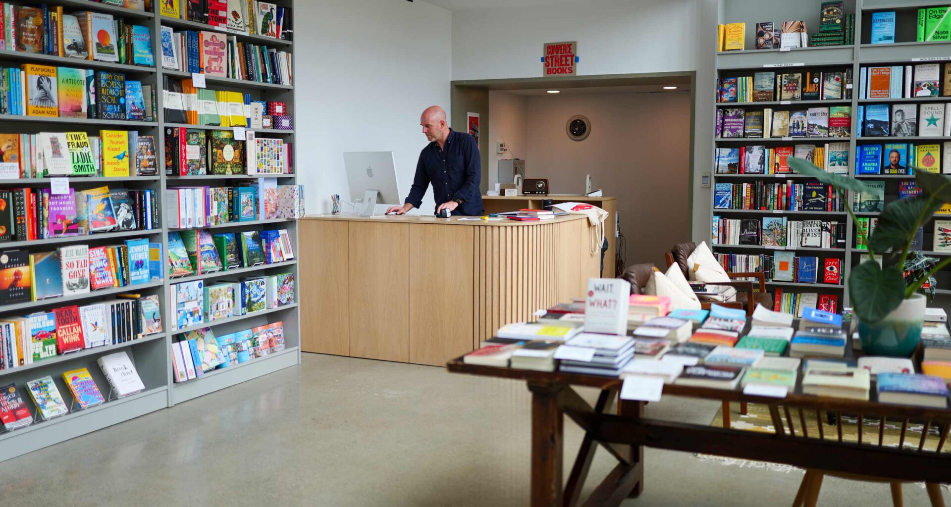 Philip Lorish at the counter of his bookstore ‘Commerce Street Books’