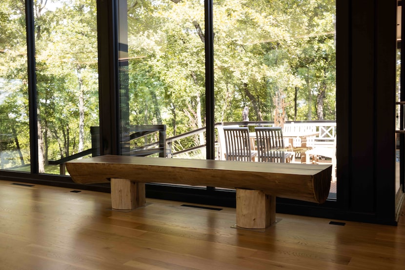 A black walnut log from Oklahoma is sliced in half and used as a bench.