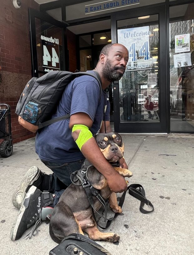 Charles Williams hugs his American Bully dog, Roc, after they were reunited outside the NYPD's 44th Precinct stationhouse in the Bronx on Thursday, Aug. 14, 2025. (Julian Roberts-Grmela / New York Daily News)