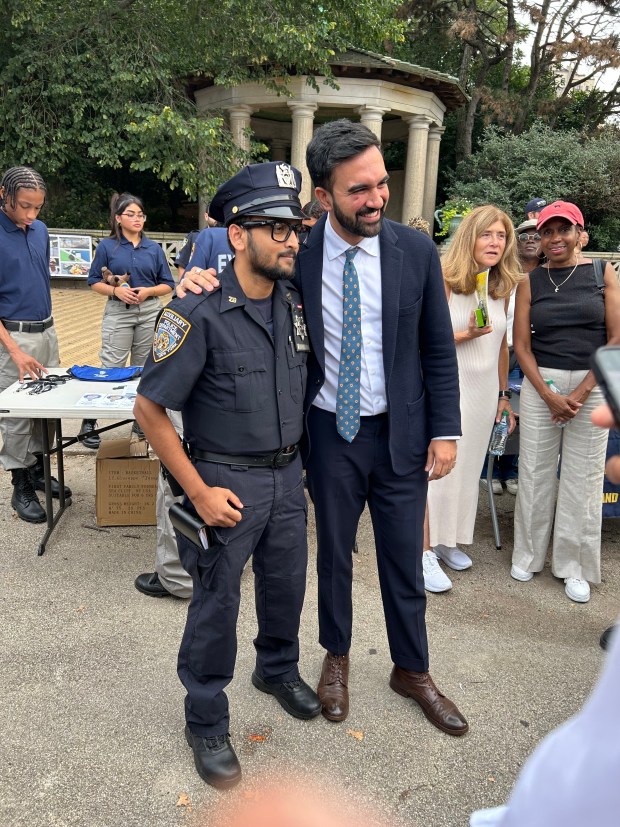 Zohran Mamdani and an NYPD officer from 78th precinct on August 5, 2025. (Chris Sommerfeldt/NYDN) 