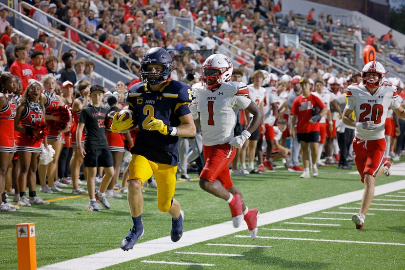 Highland Park's Cannon Bozman (2) runs for a touchdown as Rockwall-Heath's Quincy Jones (1)...