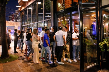 In this 2021 DMN file photo, customers wait outside on the streets of Deep Ellum to get into...