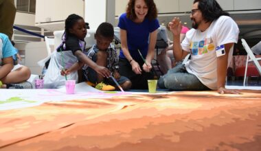 Jane Golden and Cesar Viveros painting a Pope Francis mural in 2015.
