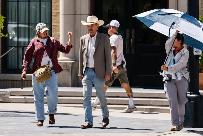 Actor Billy Bob Thornton walks with production crew members while filming Season Two of the...