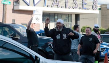 T.H. Styles (center) of Philadelphia, a 24-year stagehand, encourages people to honk their horns as IATSE (International Alliance of Theatrical Stage Employees) union members parade around the 2300 Arena in their cars in Philadelphia on Wednesday.