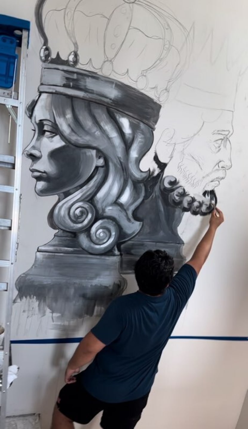 One of Carl Hess' art students painting inside the home at 1401 Seegar St. in Dallas.