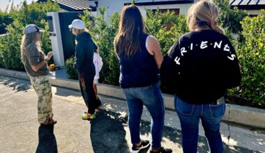 Mourners stand outside the home of actor Matthew Perry, Sunday, Oct. 29, 2023, in the Pacific Palisades area of Los Angeles. Perry, who starred as Chandler Bing in the hit series "Friends," has died. He was 54. (AP Photo/Eugene Garcia)