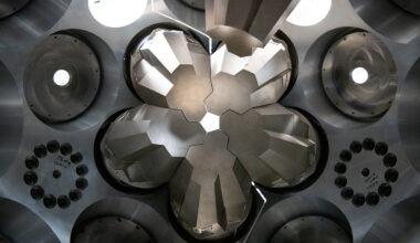 A close-up view of the GRETA interior. Silver-grey modules are arranged in a flower-like configuration around a small central opening. and surrounded by metallic housing with circular ports.