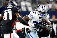 Dallas Cowboys running back Phil Mafah (37) runs the ball as Atlanta Falcons cornerback...