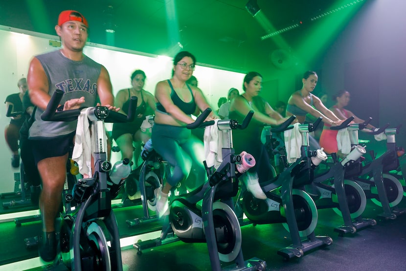 Riders take part in an evening cycling class at iiCE Fitness, Monday, July 28, 2025, in Dallas.