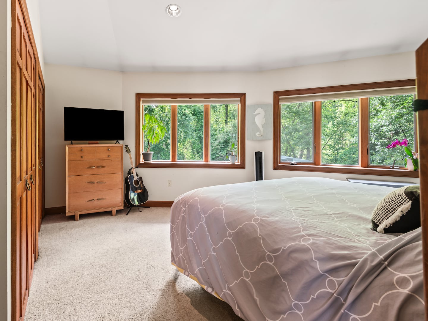 The primary bedroom features a double closet and wall-to-wall carpeting. 