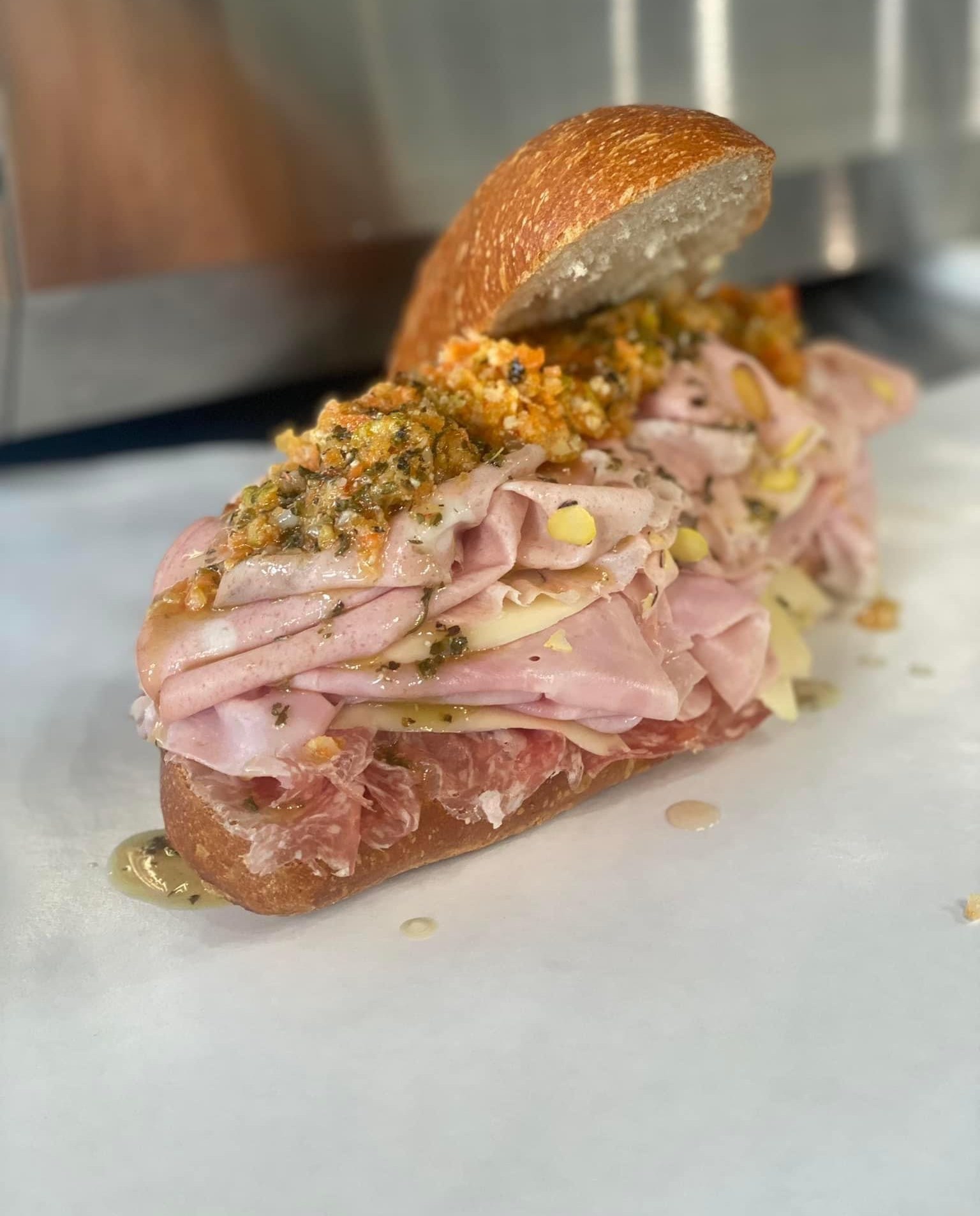 A sandwich with a pile of shaved meat.