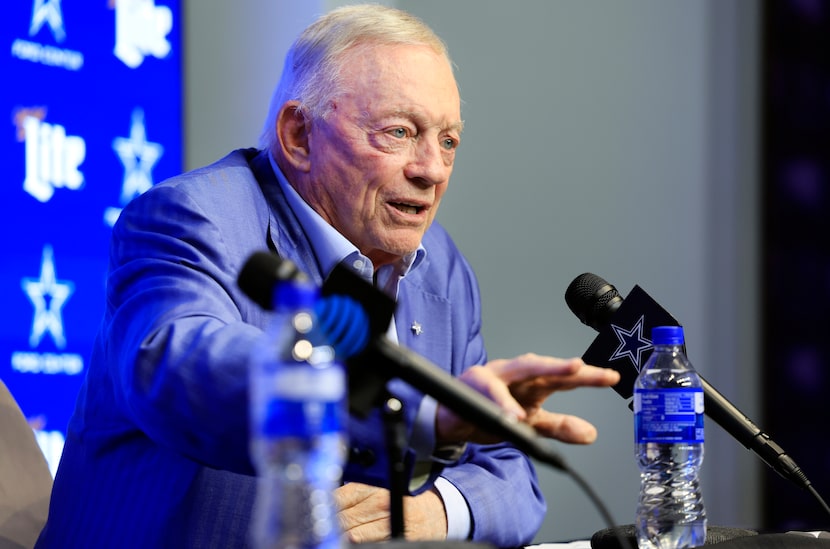 Dallas Cowboys owner Jerry Jones (right) responds a reporters question about trading...
