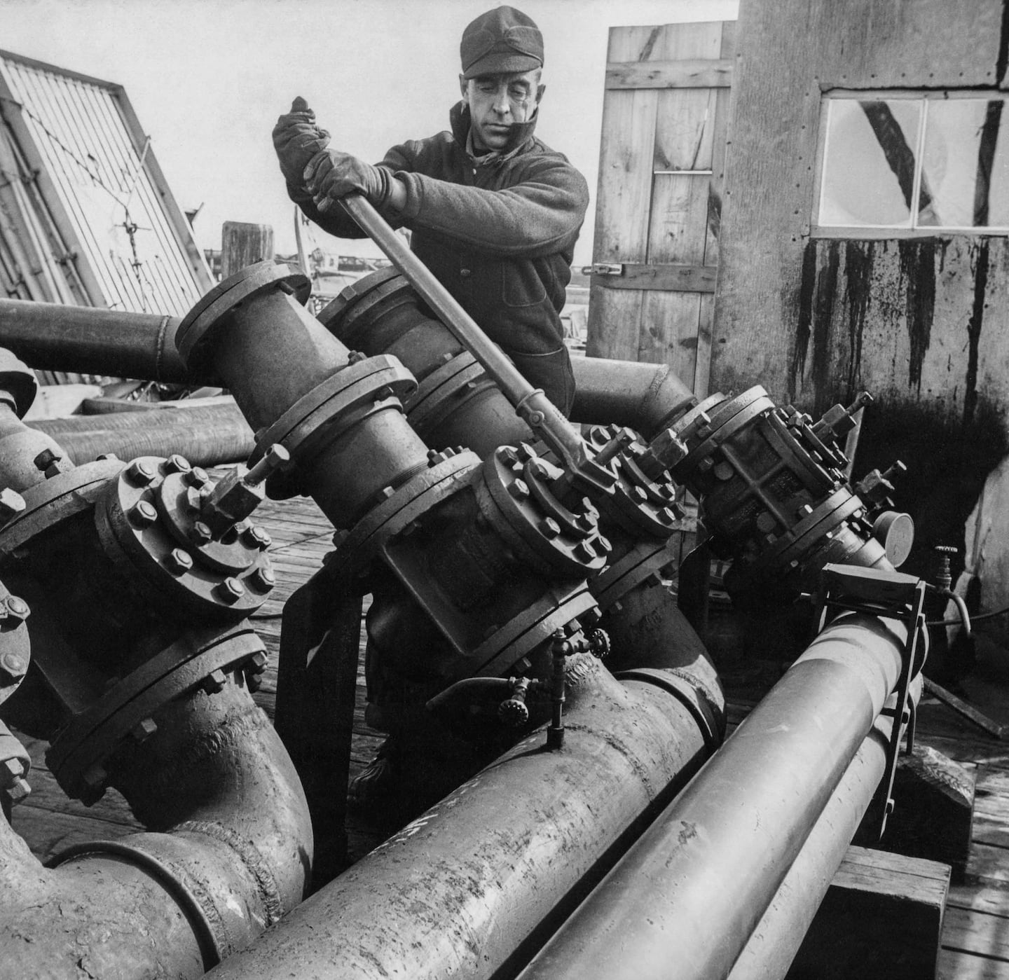 Gordon Parks, "Worker from Portland Bulk Plant opens a control valve," 1944.