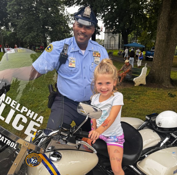 Emma Szlanic got the thrill of sitting on Officer Cliff...