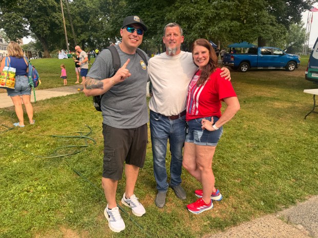 Officer Damian Caggiano, with volunteers Steve Aldinger and Lisa Hoback,...