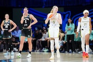Dallas Wings guard Paige Bueckers (5) laughs with guard DiJonai Carrington as Bueckers runs...