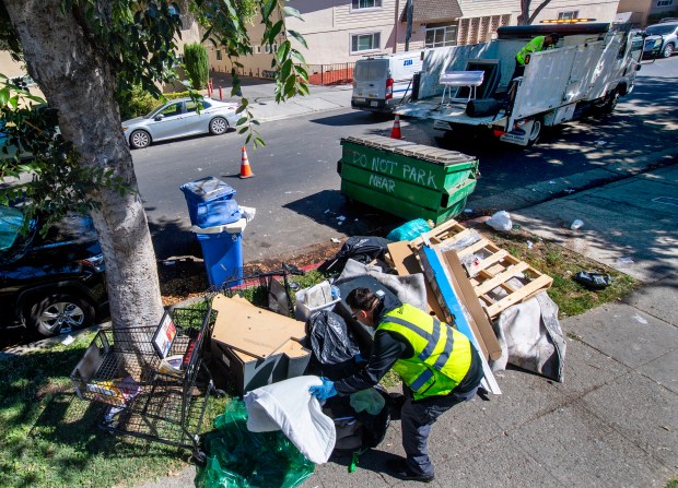 Alonzo Perez, a Senior Maintenance Worker for the City of San Jose, left, and Javier Valencia, a Maintenance Worker 2, picks up trash that has been illegally dumped on Cadillac Drive in San Jose, Calif., on Tuesday, Aug. 19, 2025. Stretches of San Jose streets have become dumping grounds for unwanted household items, including mattresses, stoves, and refrigerators. But after a concerted effort to crack down on blight, city officials believe they are making progress to curb residents from discarding their unwanted junk. (Doug Duran/Bay Area News Group)