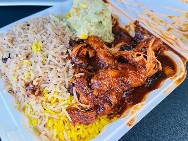 Flavors of East Africa lunch combo with spicy and sweet jerk chicken, coconut rice and mukimo.(Carlos Rico / The San Diego Union-Tribune)