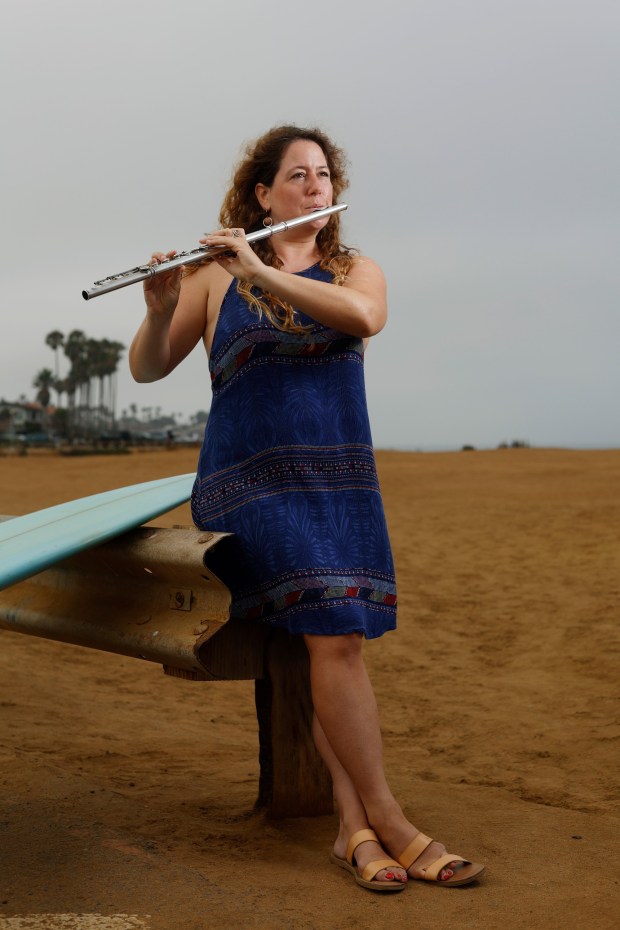 San Diego Symphony principal flute Rose Lombardo is also an avid surfer. She's shown here at Sunset Cliffs on Aug. 7, 2025. in San Diego, CA. (K.C. Alfred / The San Diego Union-Tribune)