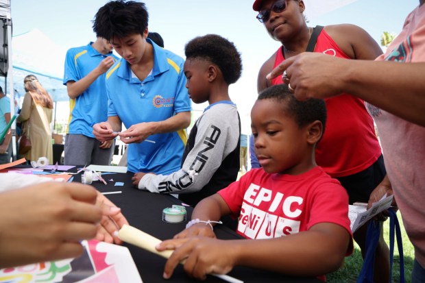 Kainon Maxwell makes a paper rocket during the second annual Southeast San Diego Science & Art Expo at Elementary Institute of Science on Saturday, Aug. 30, 2025 The expo was an inclusive Science fair highlighted science, art, and culture in the world around us including demonstrations in the engineering of lowriders, the science of tortillas, a robotics playground, music, and more. (Sandy Huffaker / For The San Diego Union-Tribune)