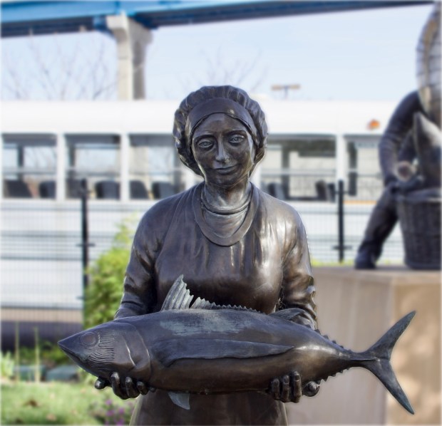 Historical photo - bronze of woman and fish, for Food story on San Diego Seafood cookbook. (Neva Sullaway)