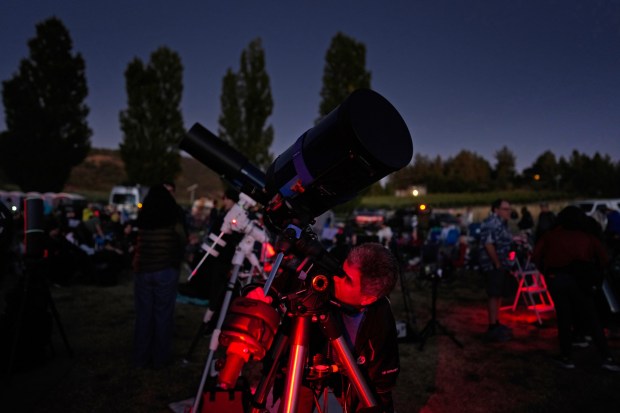 Jaime Villegas with the Mira Mesa Astronomy group calibrated his 8-inch telescope during the San Diego Dark Sky Festival held at Menghini Winery in Julian on Saturday, Aug. 16, 2025.  (Nelvin C. Cepeda / The San Diego Union-Tribune)