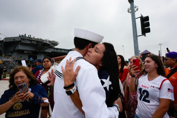 Christy Trevino from Amarillo, Texas, hugs her son, Ezra Trevino, who was among the sailors onboard the USS Carl Vinson who returned from deployment to their homeport at Naval Air Station North Island on Thursday, Aug. 14, 2025, in Coronado, CA. (Nelvin C. Cepeda / The San Diego Union-Tribune)