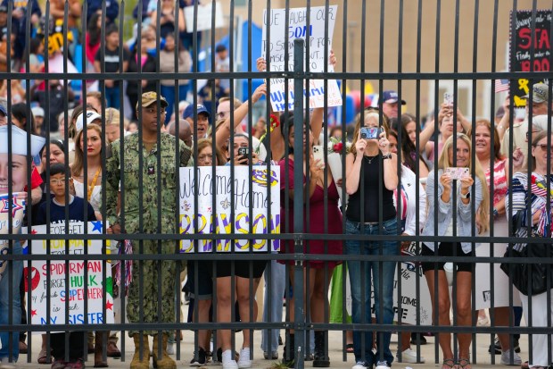 Family and friends wait just outside the secure dock for their sailors assigned to the Carl Vinson to pull into San Diego Bay. Sailors on board the USS Carl Vinson returned from deployment to their homeport at Naval Air Station North Island on Thursday, Aug. 14, 2025, in Coronado, CA. (Nelvin C. Cepeda / The San Diego Union-Tribune)