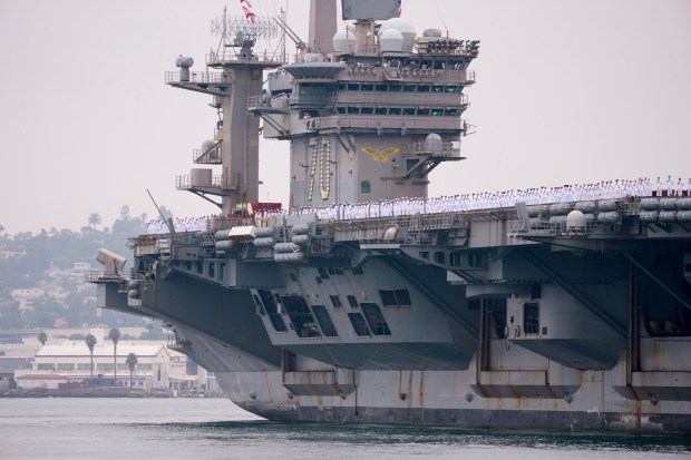 Sailors man the rails as the Carl Vinson pulls into San Diego Bay. Sailors on board the USS Carl Vinson returned from deployment to their homeport at Naval Air Station North Island on Thursday, Aug. 14, 2025, in Coronado, CA. (Nelvin C. Cepeda / The San Diego Union-Tribune)