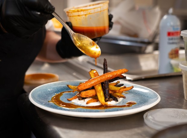 Emily Brubaker, resort executive chef at Omni La Costa in Carlsbad, prepares roast carrot salad with orange coriander labneh and harissa vinaigrette's, at the Vue, one of eight restraints she oversees at the resort. She won season 1 of the NBC culinary competition show, " Yes, Chef!" hosted by Martha Stewart and chef Jose Andres to take home the $250,000 prize. Photographed Thursday July 24, 2025, in Carlsbad, California. Howard Lipin / For The San Diego Union-Tribune)