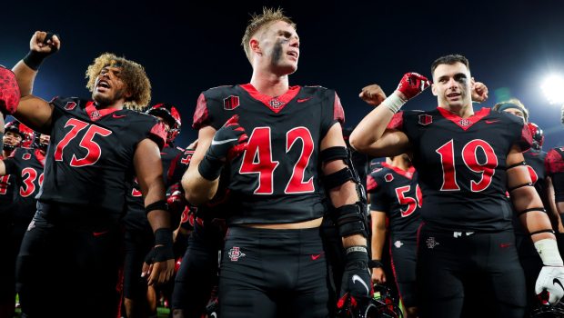 Brady Anderson #42 of the San Diego State Aztecs, center, and teammates celebrate after defeating Stony Brook during the second half at Snapdragon Stadium on Thursday, Aug. 28, 2025 in San Diego, CA. (Meg McLaughlin / The San Diego Union-Tribune)