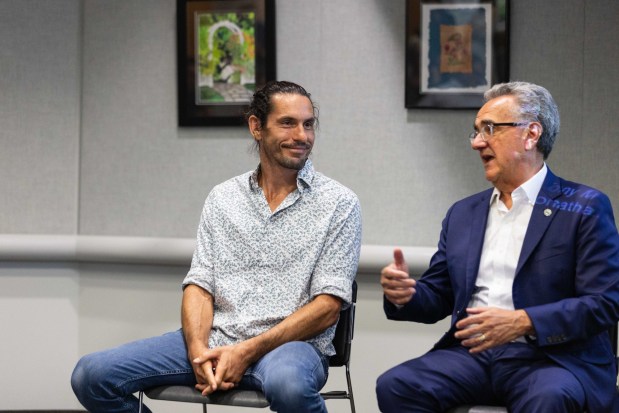 Director Nate Dappen, left, speaks with San Diego City Council President Joe LaCava at a screening of the fourth episode of "Human Footprint" on Wednesday, July 30, at the Pacific Beach library. (Zoë Meyers / For The San Diego Union-Tribune)