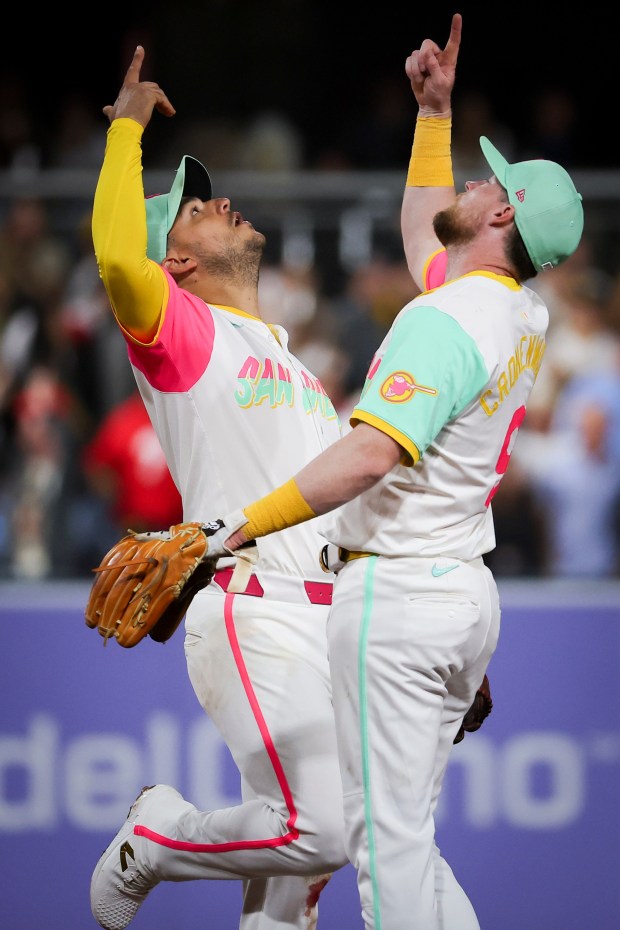 Jose Iglesias #7 of the San Diego Padres and Jake Cronenworth #9 celebrate after defeating the Philadelphia Phillies at Petco Park on Friday, July 11, 2025 in San Diego, CA. (Meg McLaughlin / The San Diego Union-Tribune)