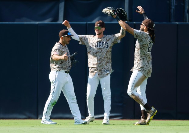 Ramón Laureano #5 of the San Diego, left, Jackson Merrill #3 and Fernando Tatis Jr. #23 celebrates after a win against the Boston Red Sox at Petco Park on Aug. 10, 2025 in San Diego, CA. (K.C. Alfred / The San Diego Union-Tribune)