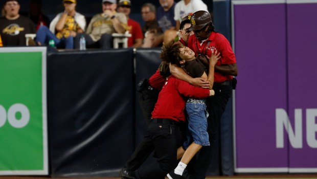 Security tackles a young fan who ran onto the field during a game between the San Diego Padres and San Francisco Giants at Petco Park on Aug. 19, 2025 in San Diego, California. (K.C. Alfred / The San Diego Union-Tribune)