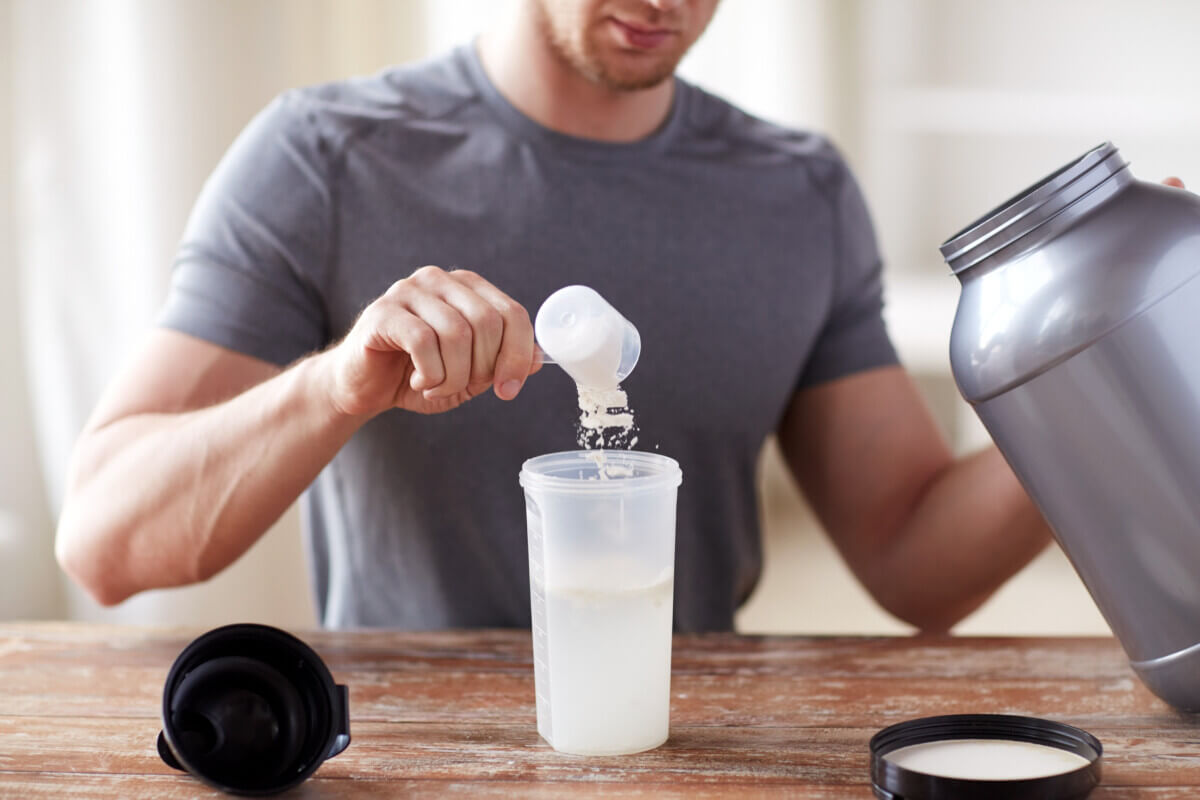 Man using health supplement powder in a shake